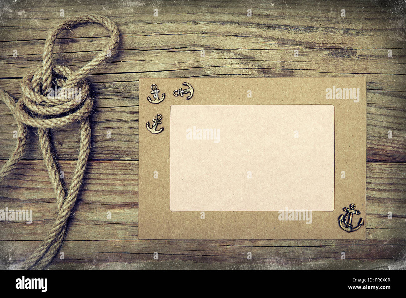 Frame with anchor on wooden boards. Stock Photo