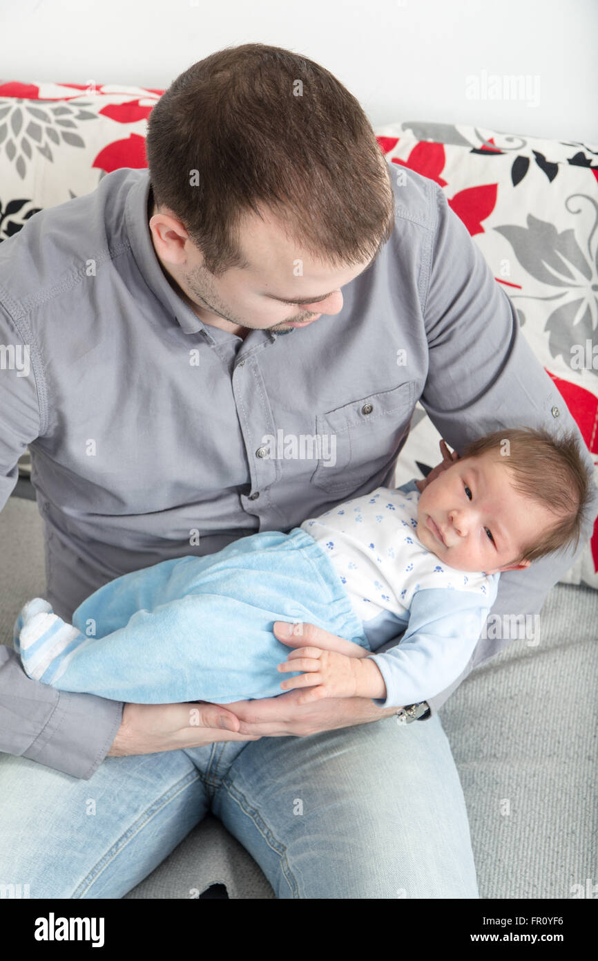 Young Father And His Little Baby Boy Together Papa With His Cheerful Newborn On Sofa Taking Good Time Domestic Family Closeup Stock Photo Alamy
