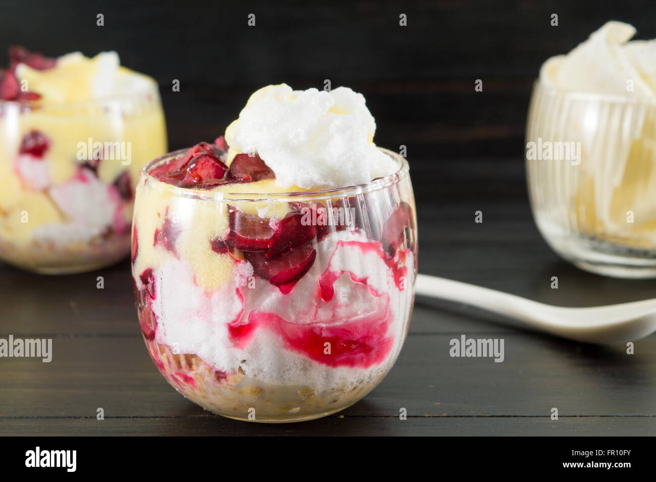 Homemade granola parfait with cherries and cream. Healthy dessert Stock Photo