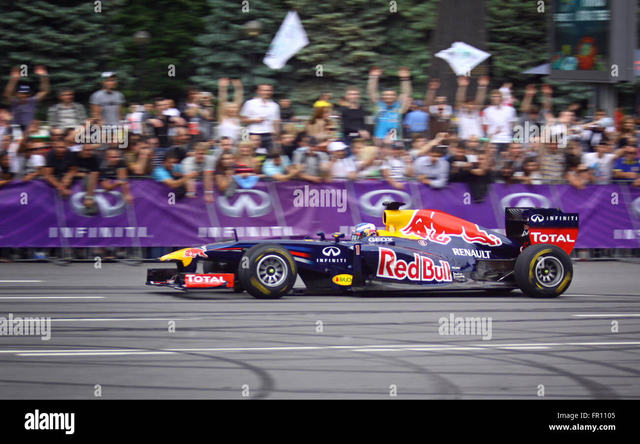 KYIV, UKRAINE - MAY 19, 2012: Daniel Ricciardo of Red Bull Racing Team drives RB7 racing car during Red Bull Champions Parade on the streets of Kyiv city Stock Photo