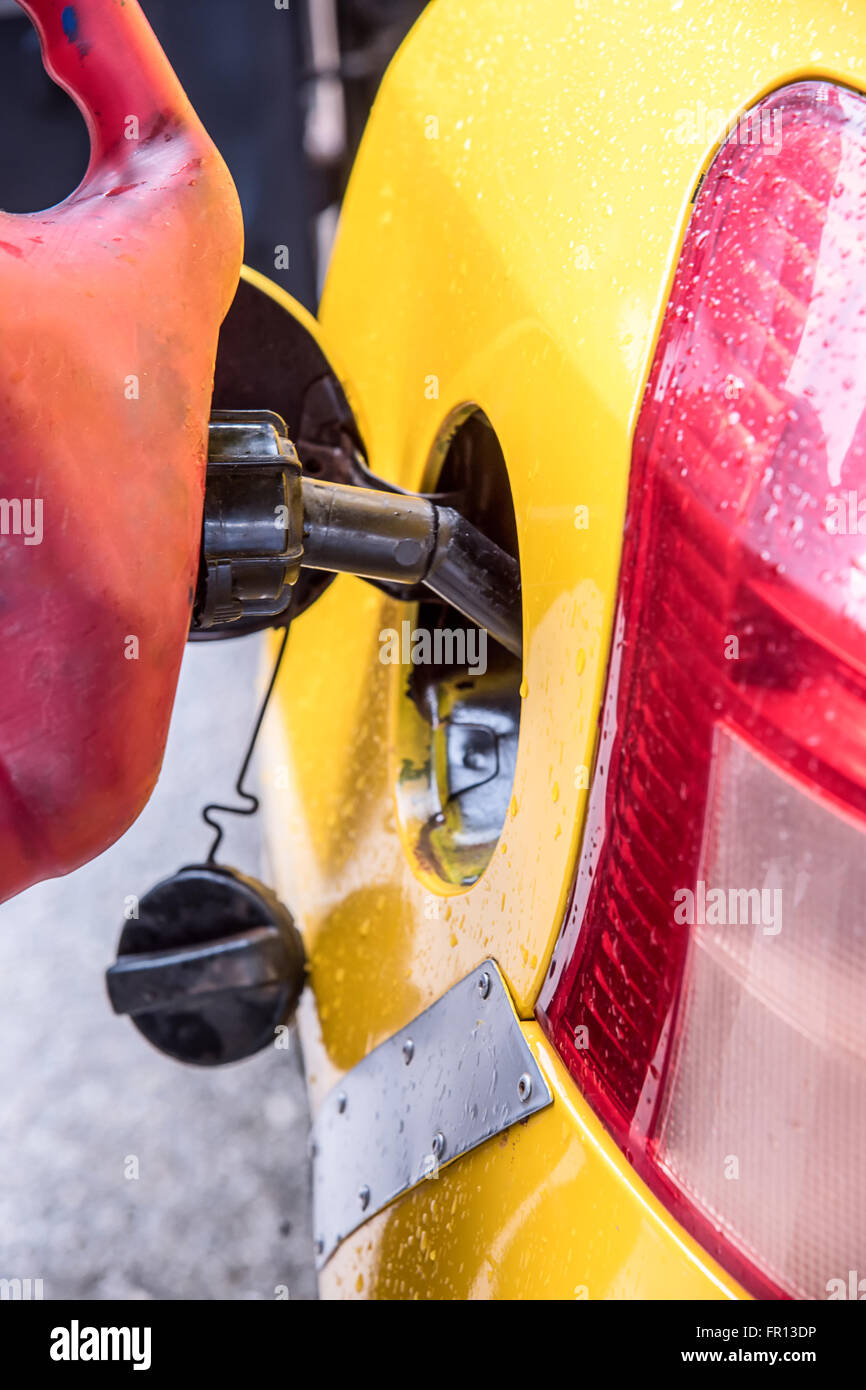 Emergency vehicle refueling, pouring fuel into gas tank from gas