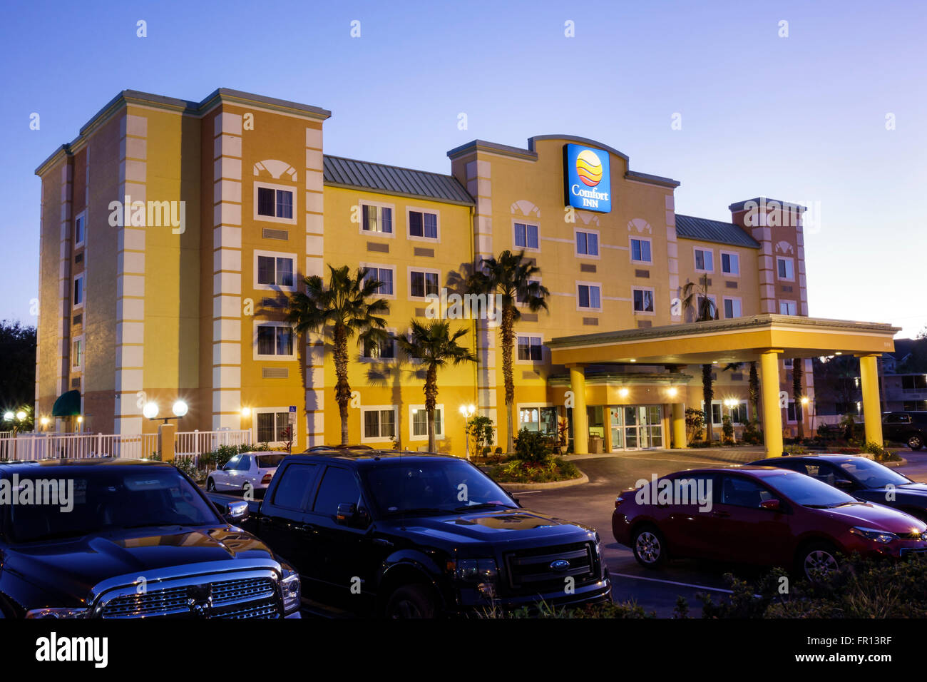 Kissimmee Florida,Orlando Comfort Inn,hotel,lodging,outside exterior,front,entrance,sign,dusk,night,FL160213043 Stock Photo