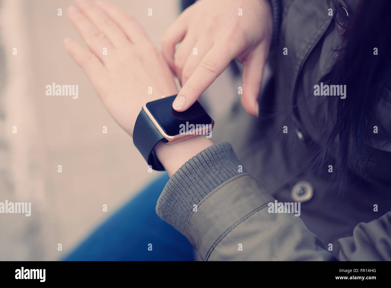 Female using her trendy smart wrist watch. This person is always connected to social media and internet. Modern technology and v Stock Photo