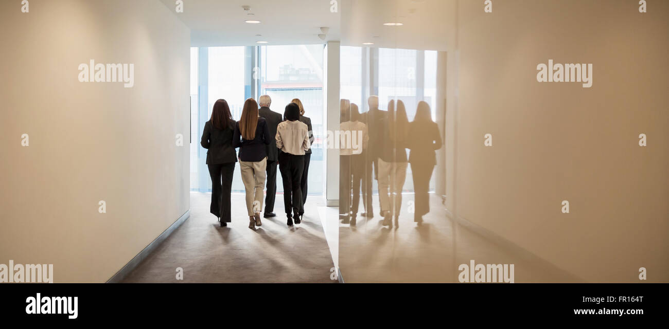 Business people walking in office corridor Stock Photo