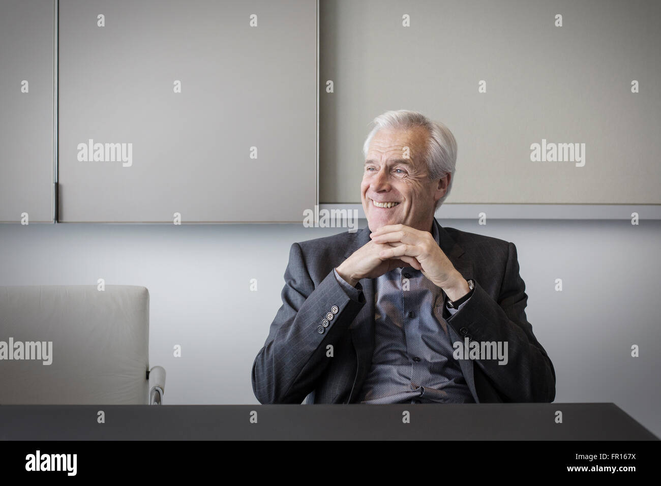 Smiling senior businessman looking away Stock Photo