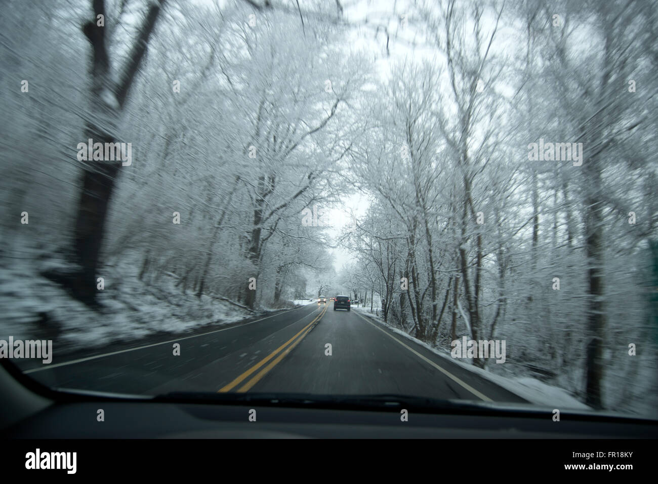 car driving on snowy country road Stock Photo - Alamy