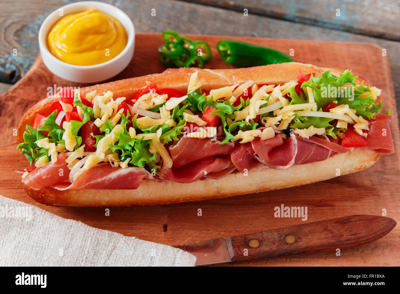 sandwich baguette ham prosciutto cheese with tomato and herbs Stock