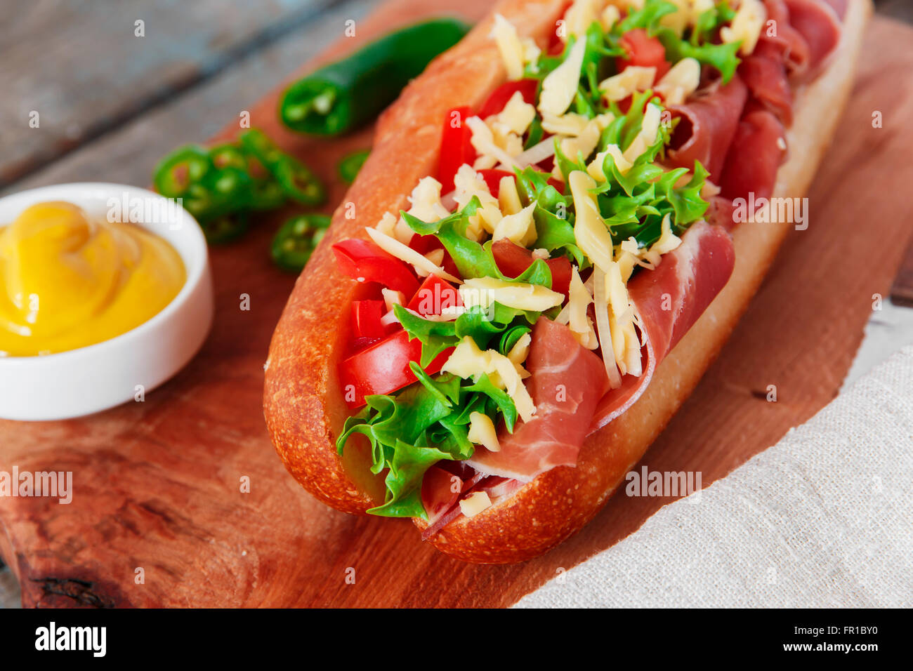 sandwich baguette ham prosciutto cheese with tomato and herbs Stock