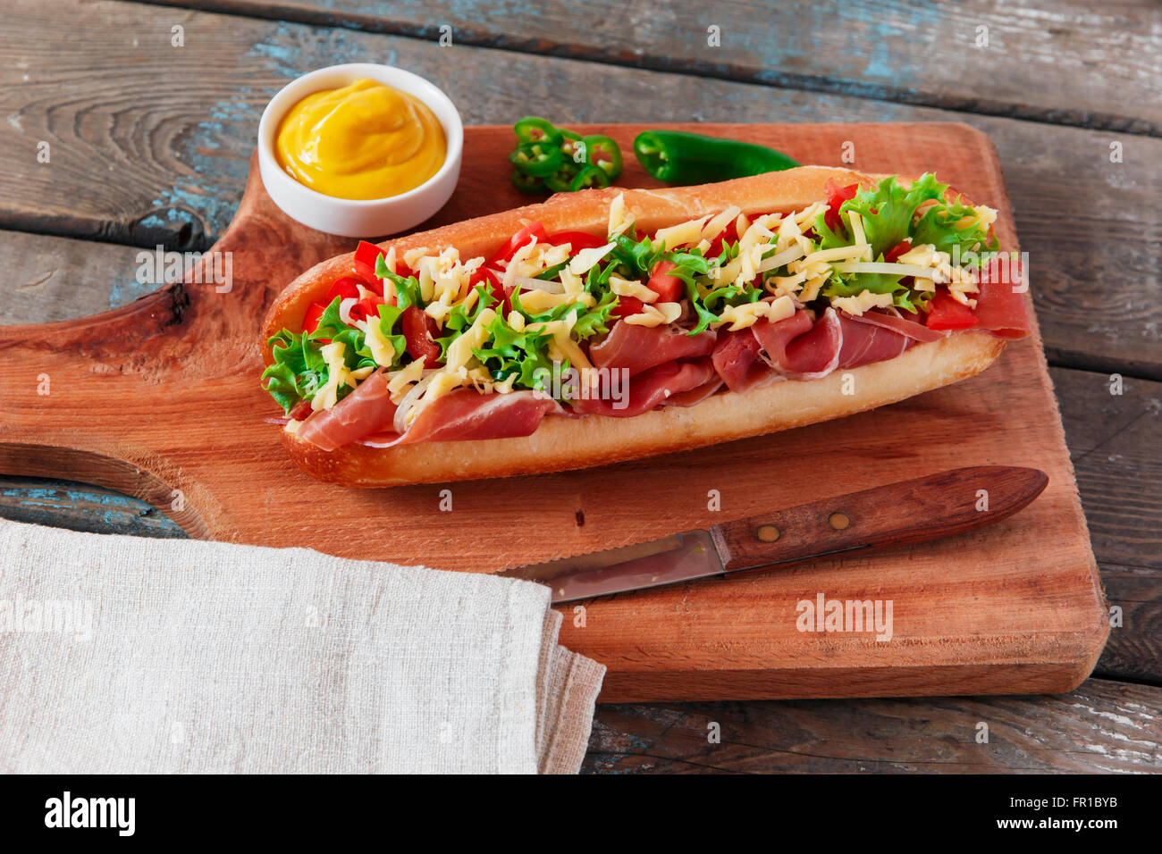 sandwich baguette ham prosciutto cheese with tomato and herbs Stock