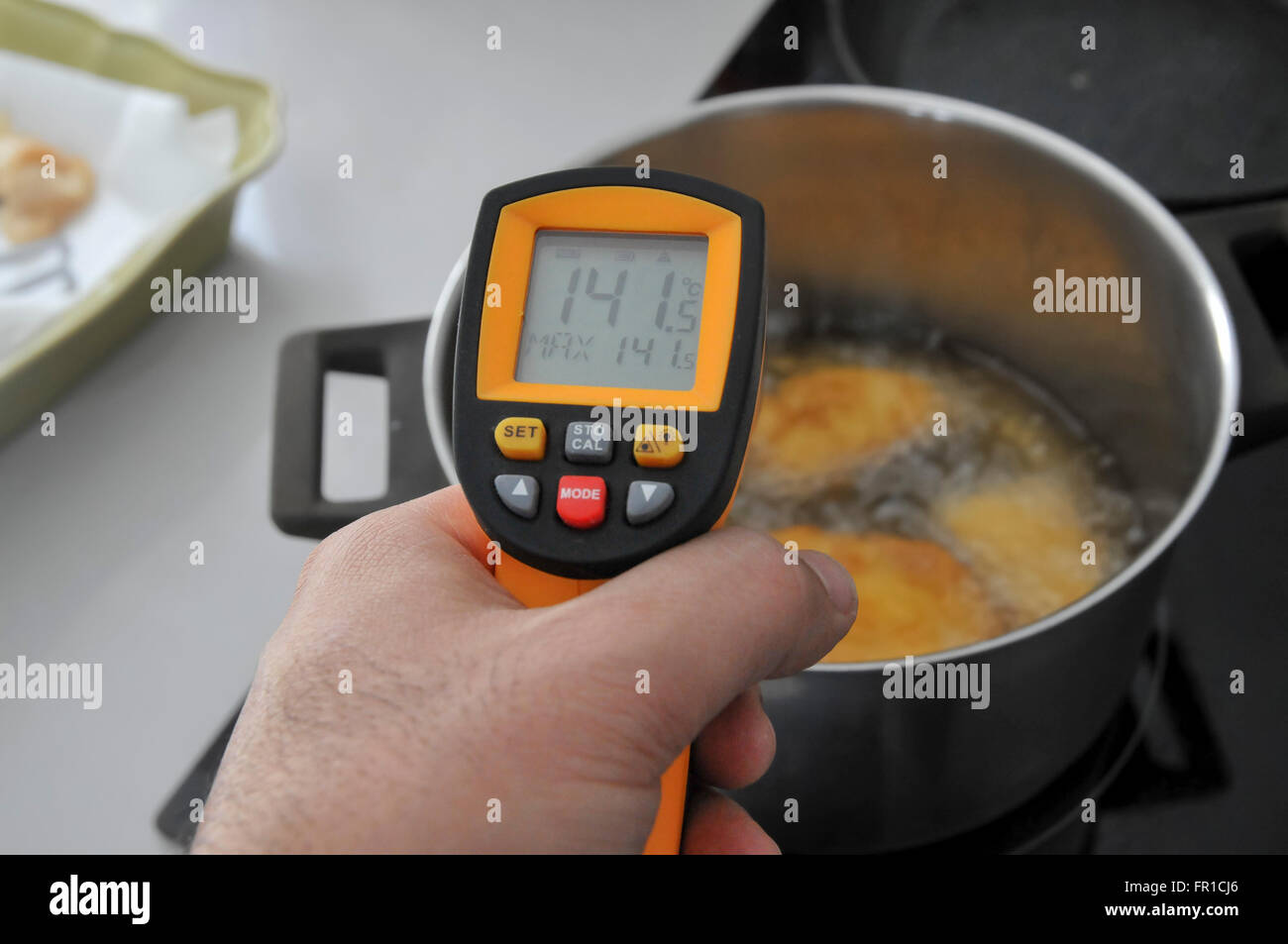Handheld laser remote thermometer measures the temperature of boiling