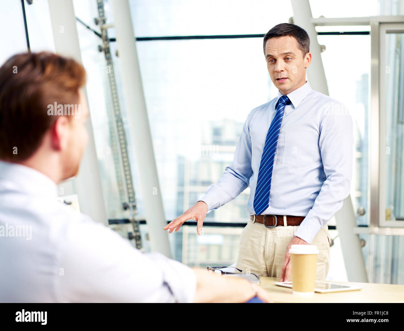 two corporate executives discussing business in office. Stock Photo