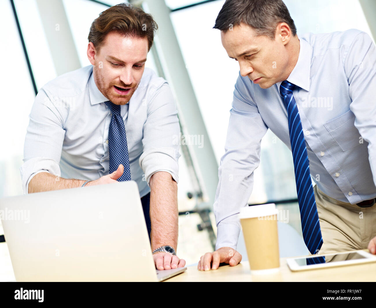 two business executives working together using laptop computer Stock Photo