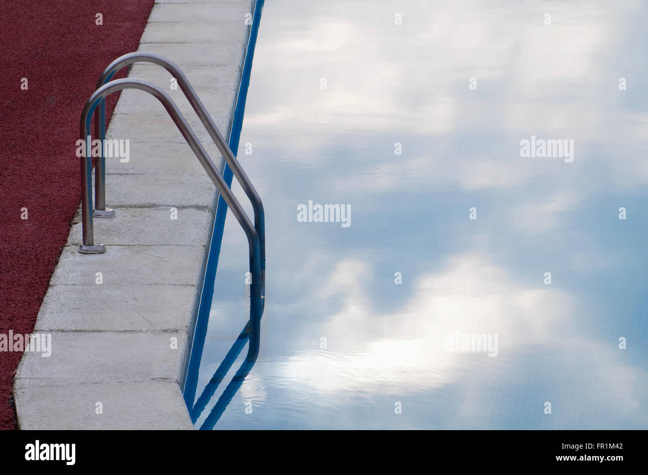 Detail of swimming pool with the sky reflected on water. Stock Photo