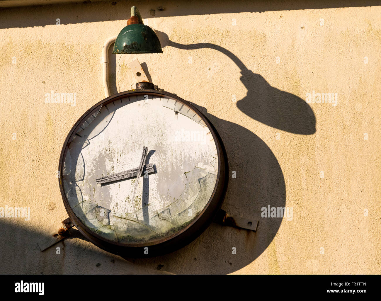 Stopped Clock Abandoned and Broken Factory Clock, Lamp and Shadows