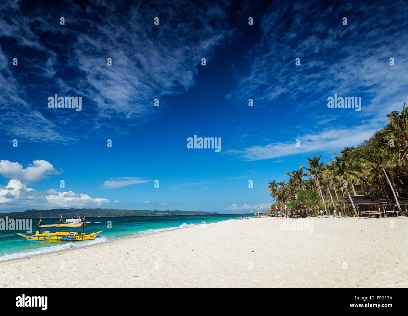 traditional filipino asian ferry taxi tour boats on puka beach in tropical boracay philippines Stock Photo