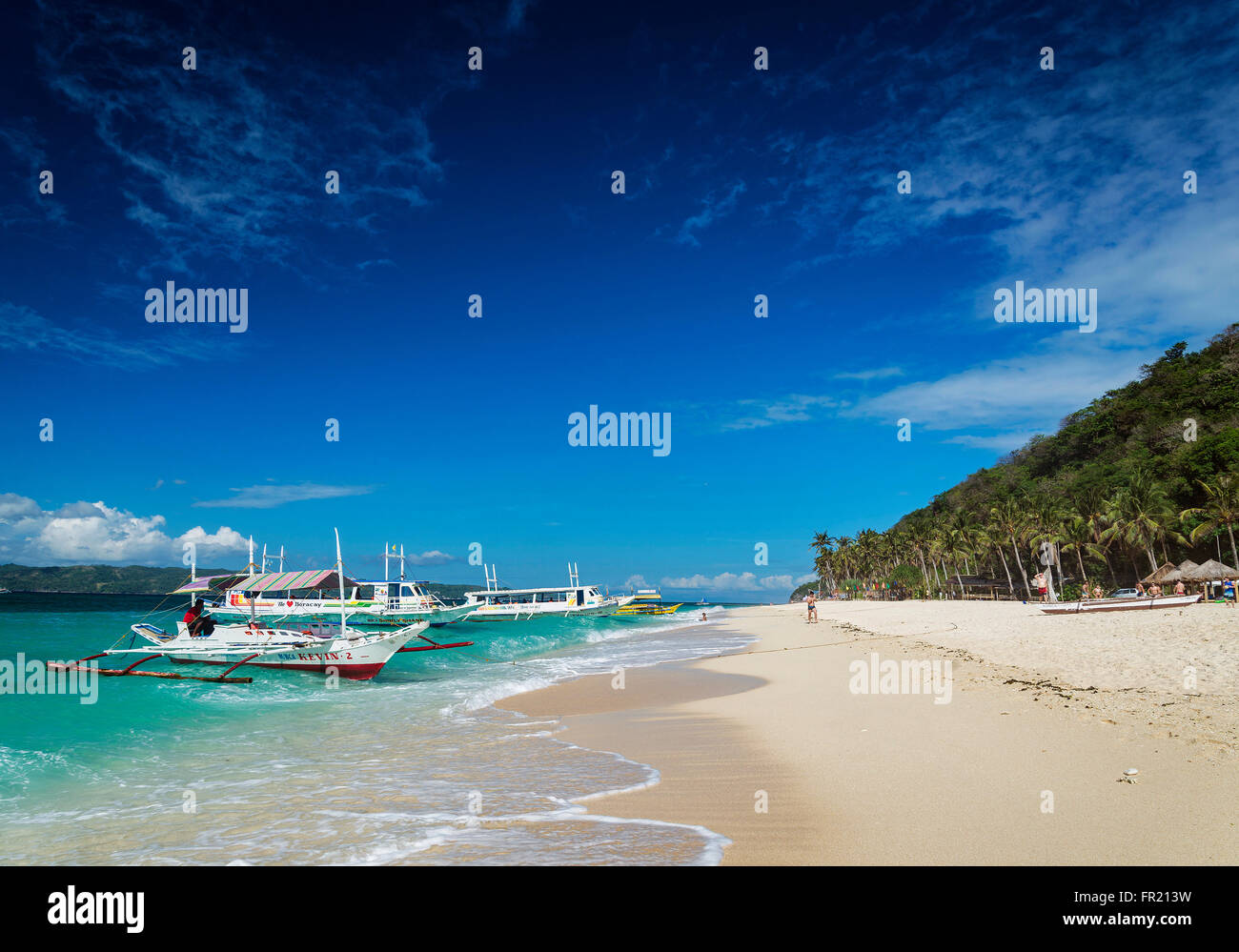 traditional filipino asian ferry taxi tour boats on puka beach in tropical boracay philippines Stock Photo