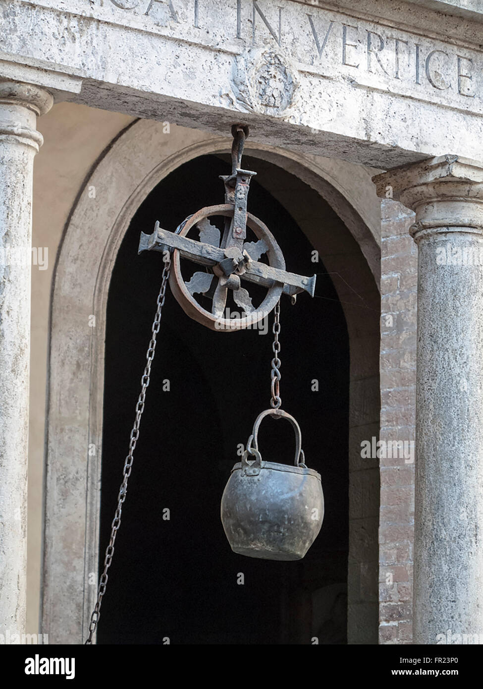 The chain and the bucket of the well in front of Palazzo Chigi Saracini in Siena in Italy Stock Photo