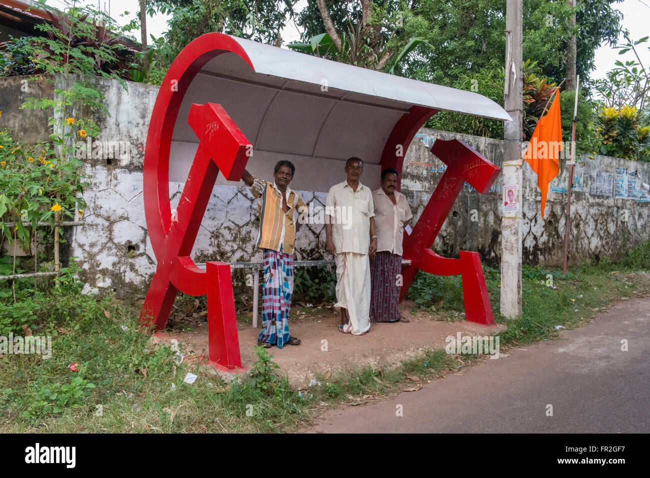 Men At Hammer and Sickle Bus Stop, Kollam Stock Photo