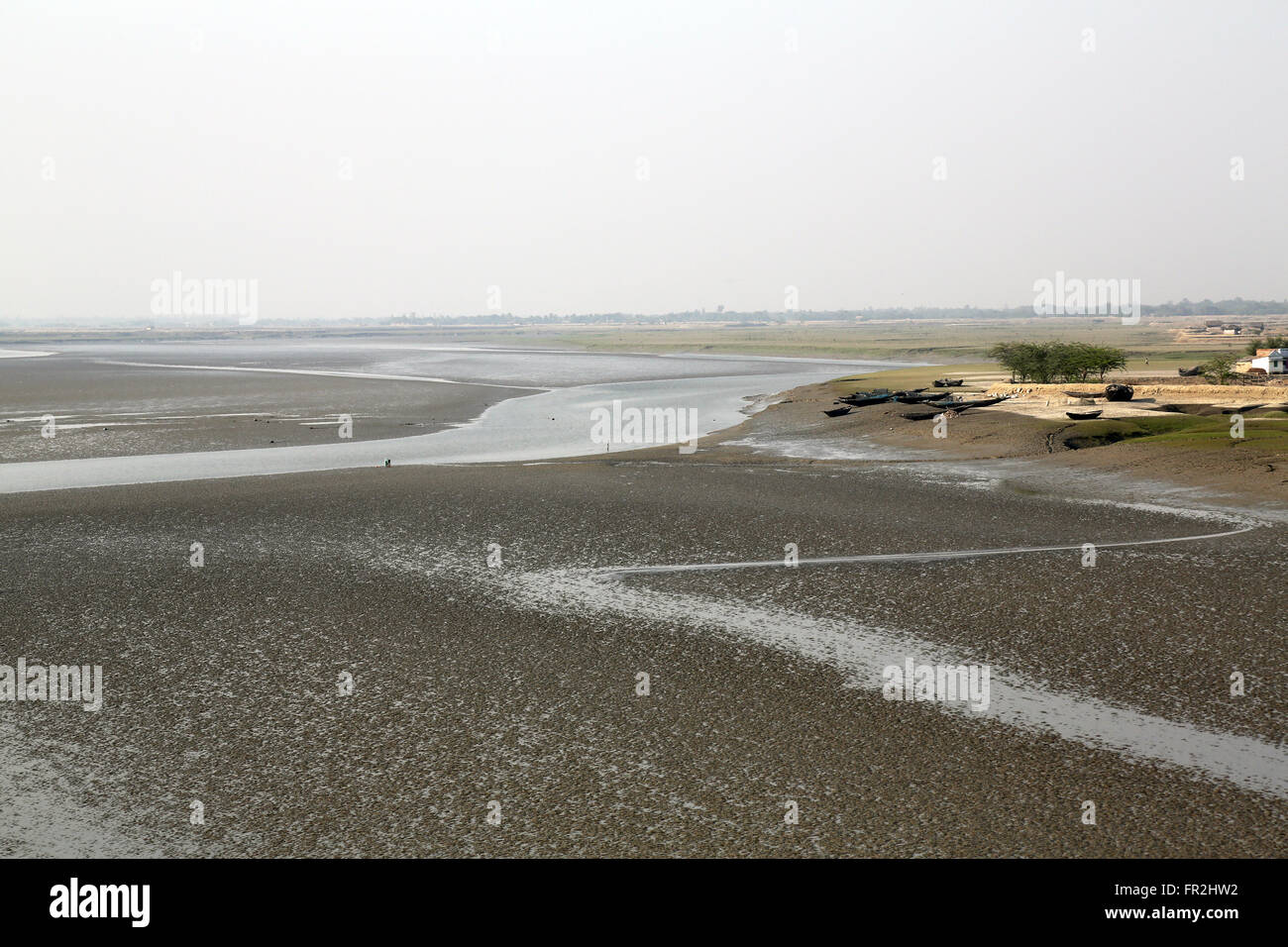 Mud beds on the river Matla during low tide the water in the Canning Town, India Stock Photo