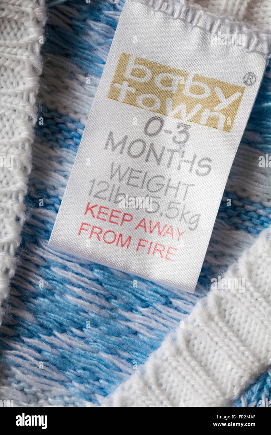 label in baby town baby's cardigan to fit 0-3 months - keep away from fire Stock Photo