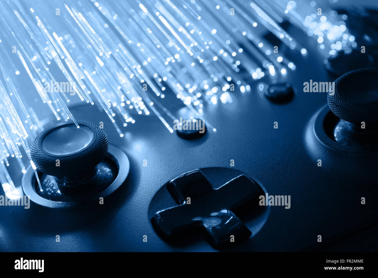 Black gamepad with optical cables next to it Stock Photo