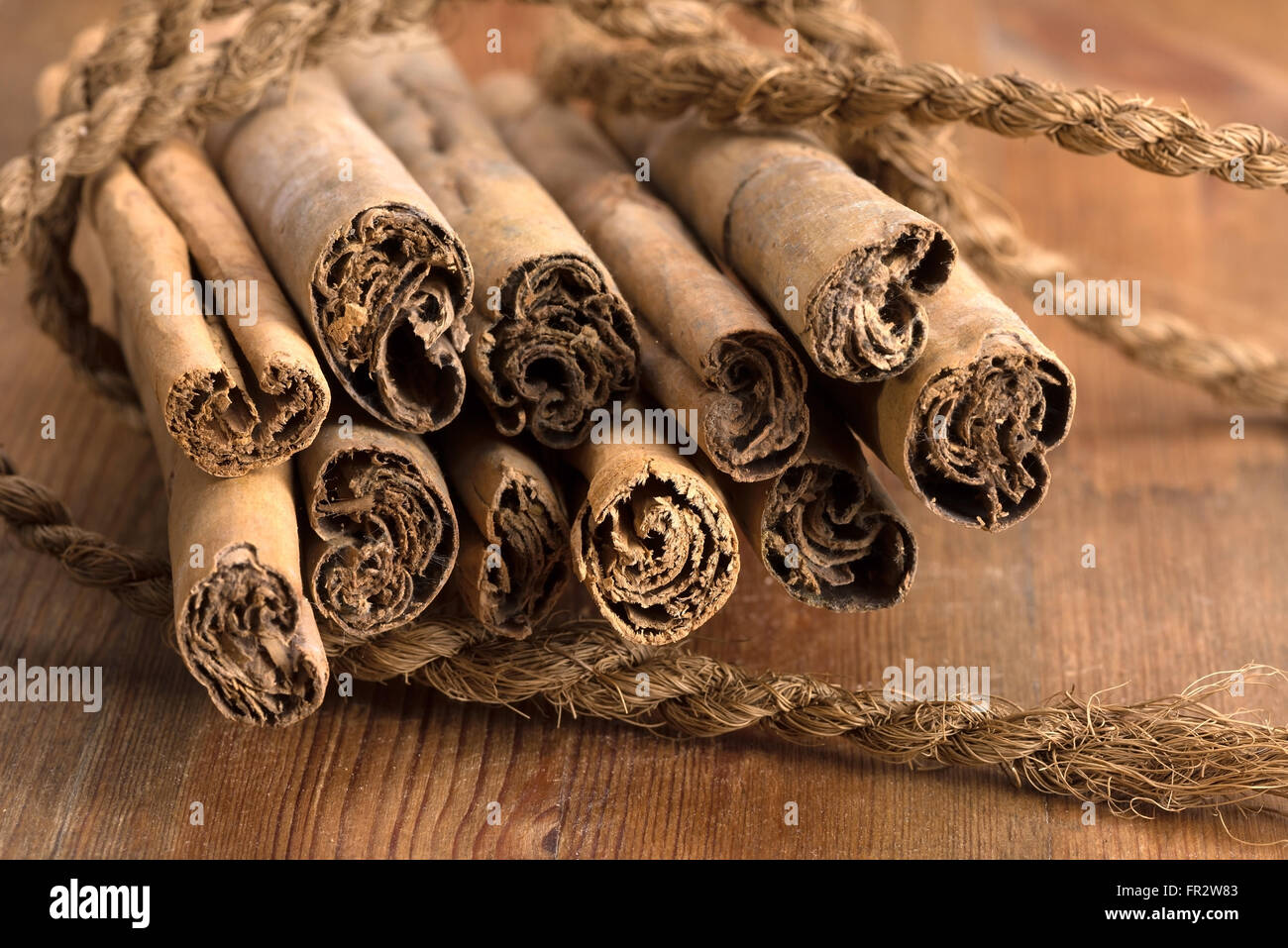 cinnamon sticks, coconut rope on old wood plate Stock Photo