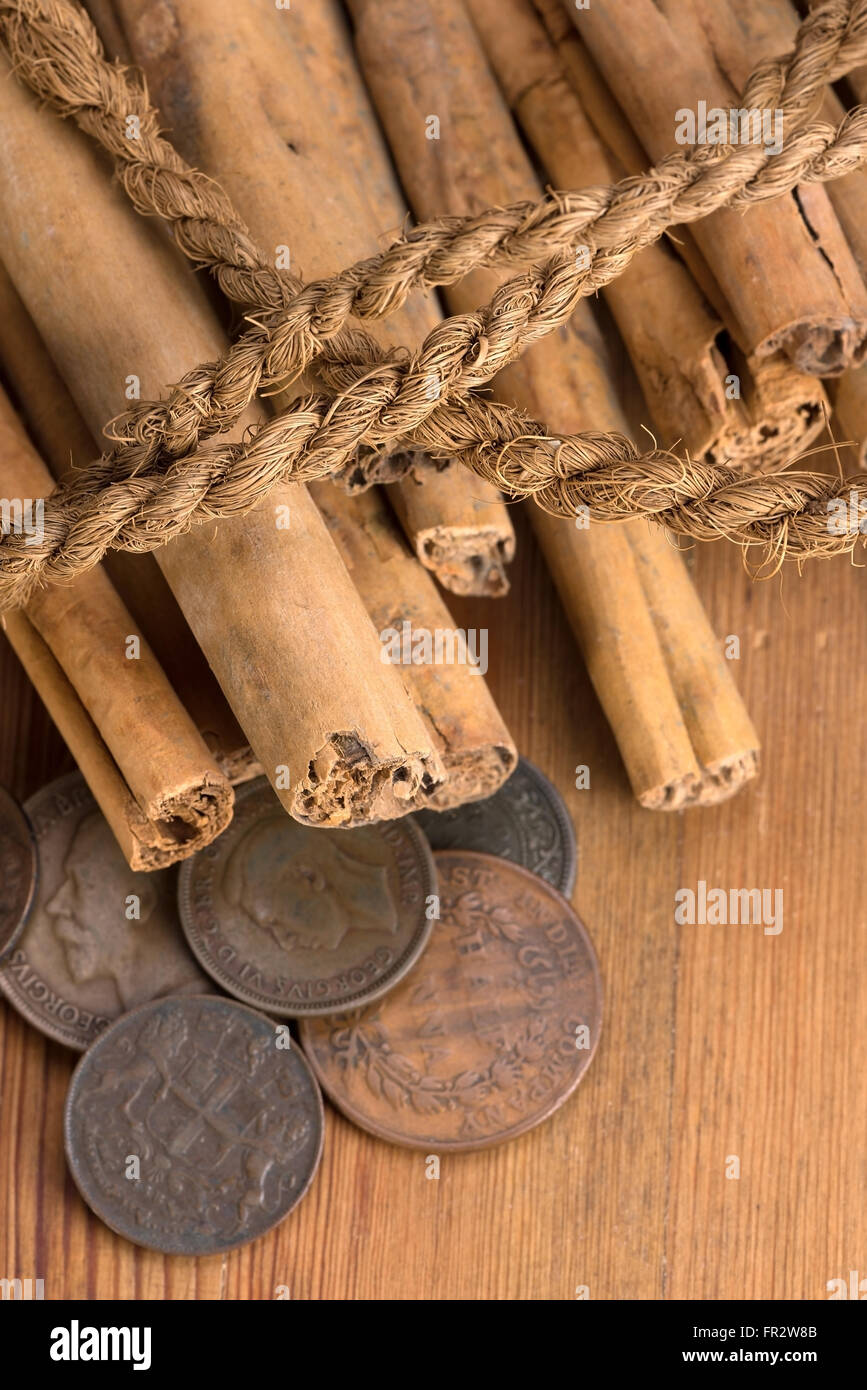 cinnamon sticks, coconut rope and old colonial coins Stock Photo