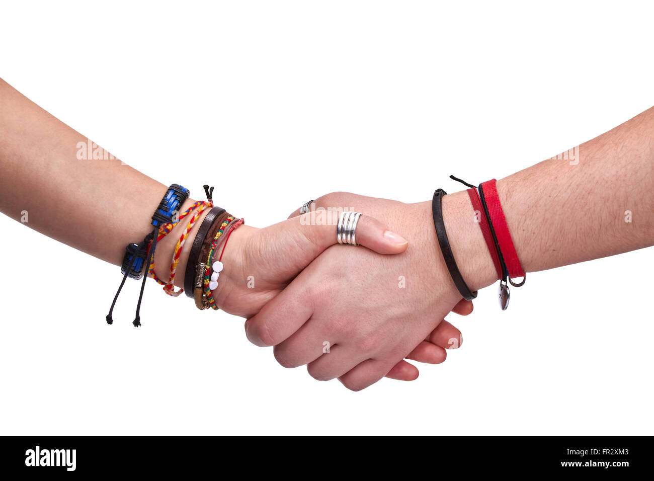 Firm handshake between a female and a male hippies with a lot of bracelets and charms on the wrists Stock Photo