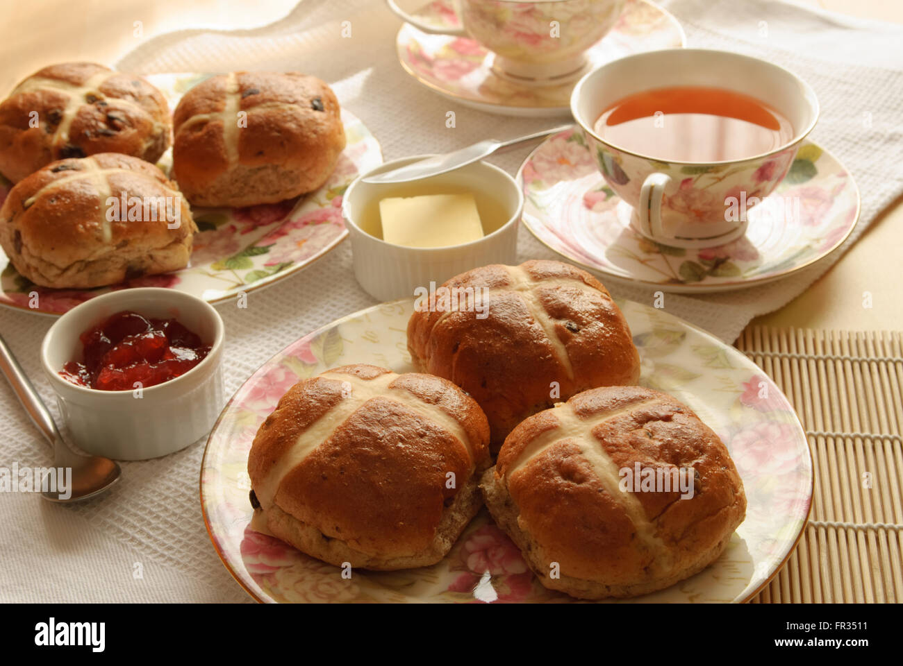 Table set with hot cross buns and tea for Easter Stock Photo