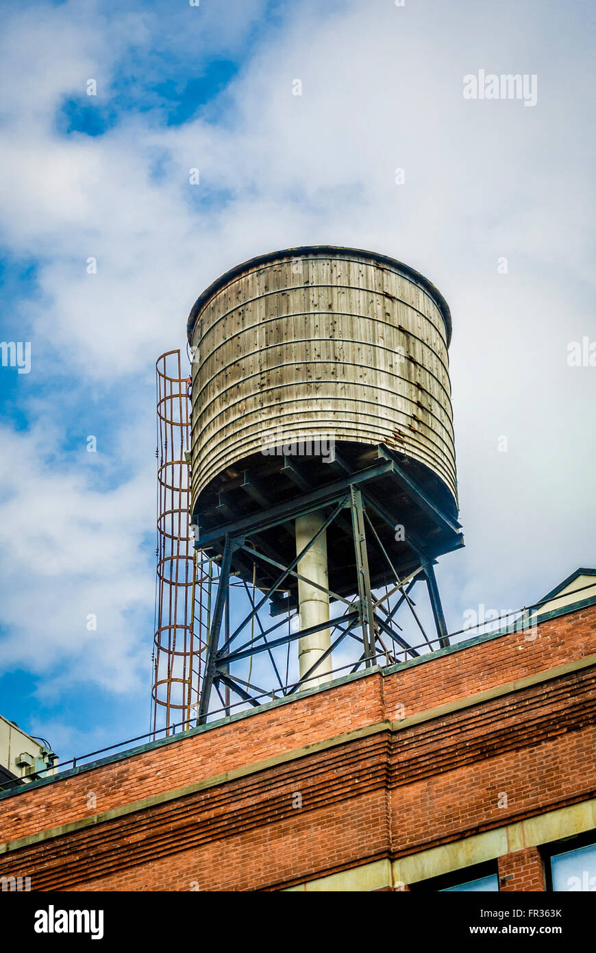 Traditional wooden Water Tower on roof of building, New York City, USA. Stock Photo