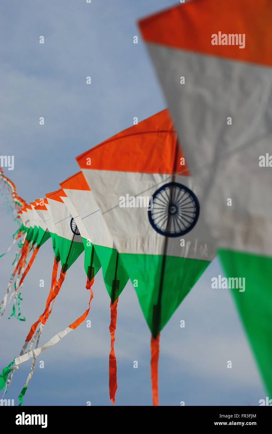 a bright and colourful Indian flag shaped kite flying during the Kite