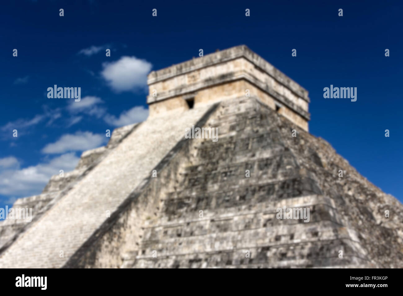 Blurred background of Mayan Pyramid to Kukulkan, the feathered serpent god, at Chichen Itza, Yucatan, Mexico. Stock Photo
