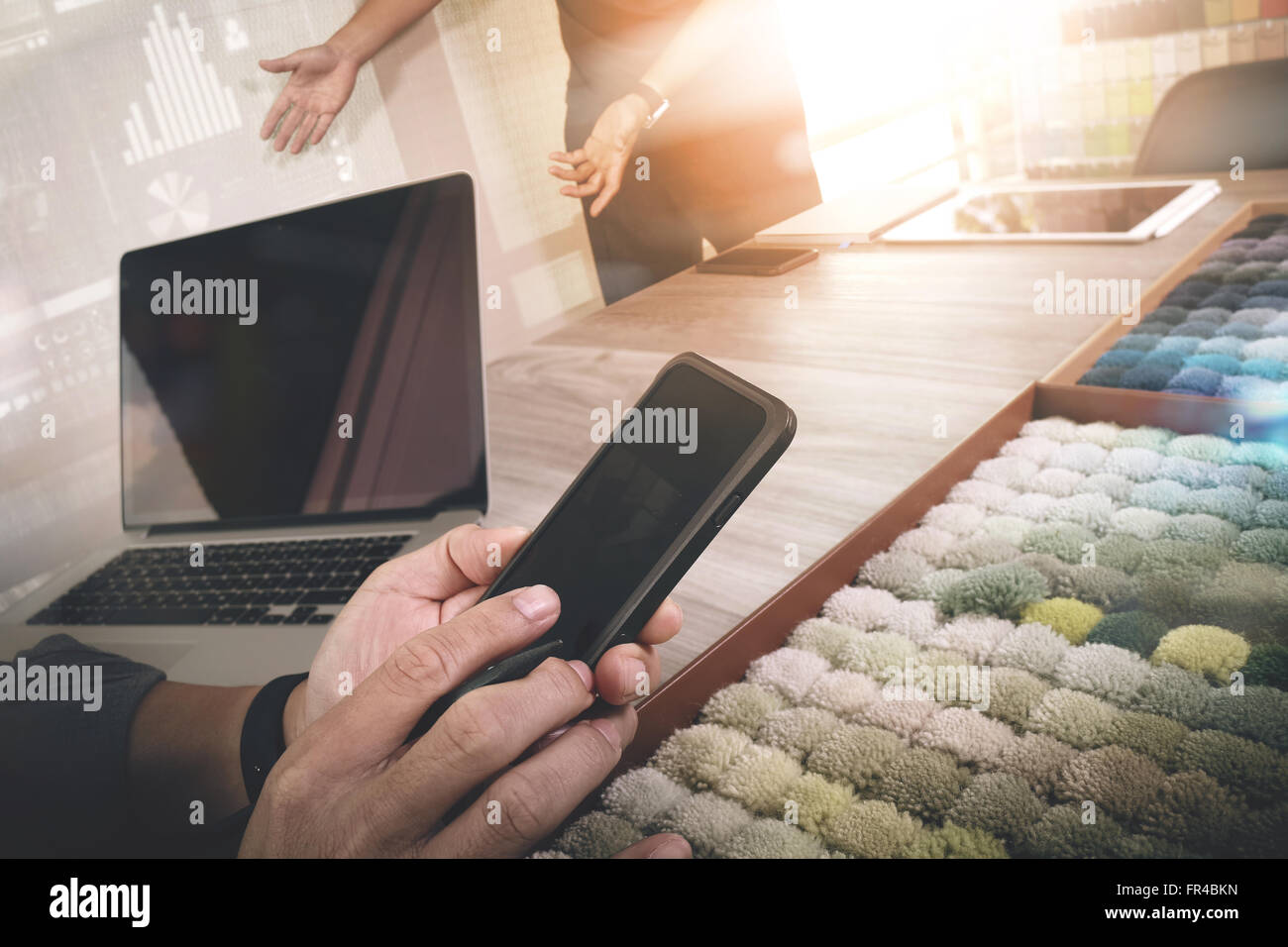 Interior Designer Hand Using Smart Phone And Choosing Carpet