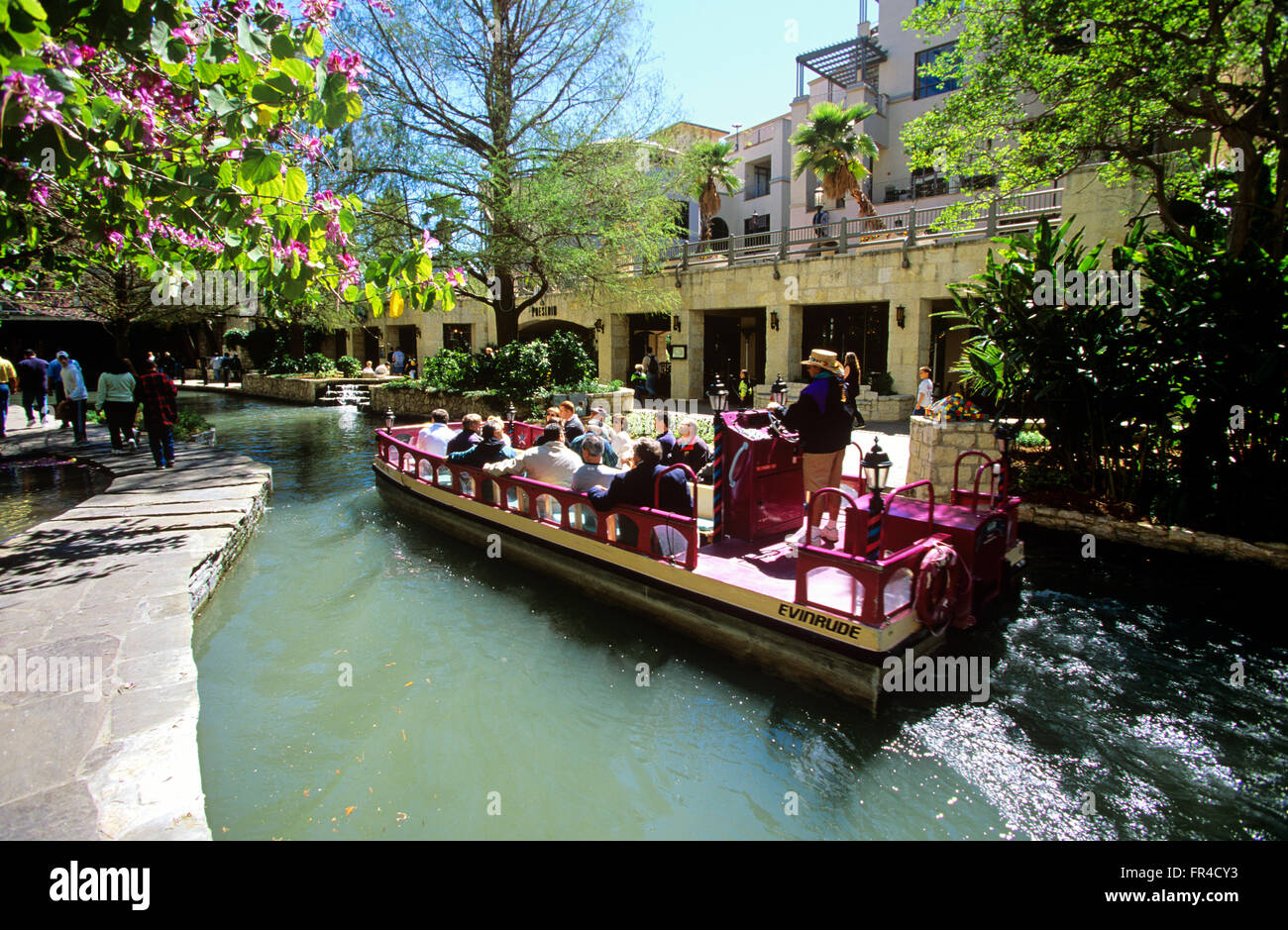 Colorful water taxis thread River Walk in downtown San Antonio, Texas