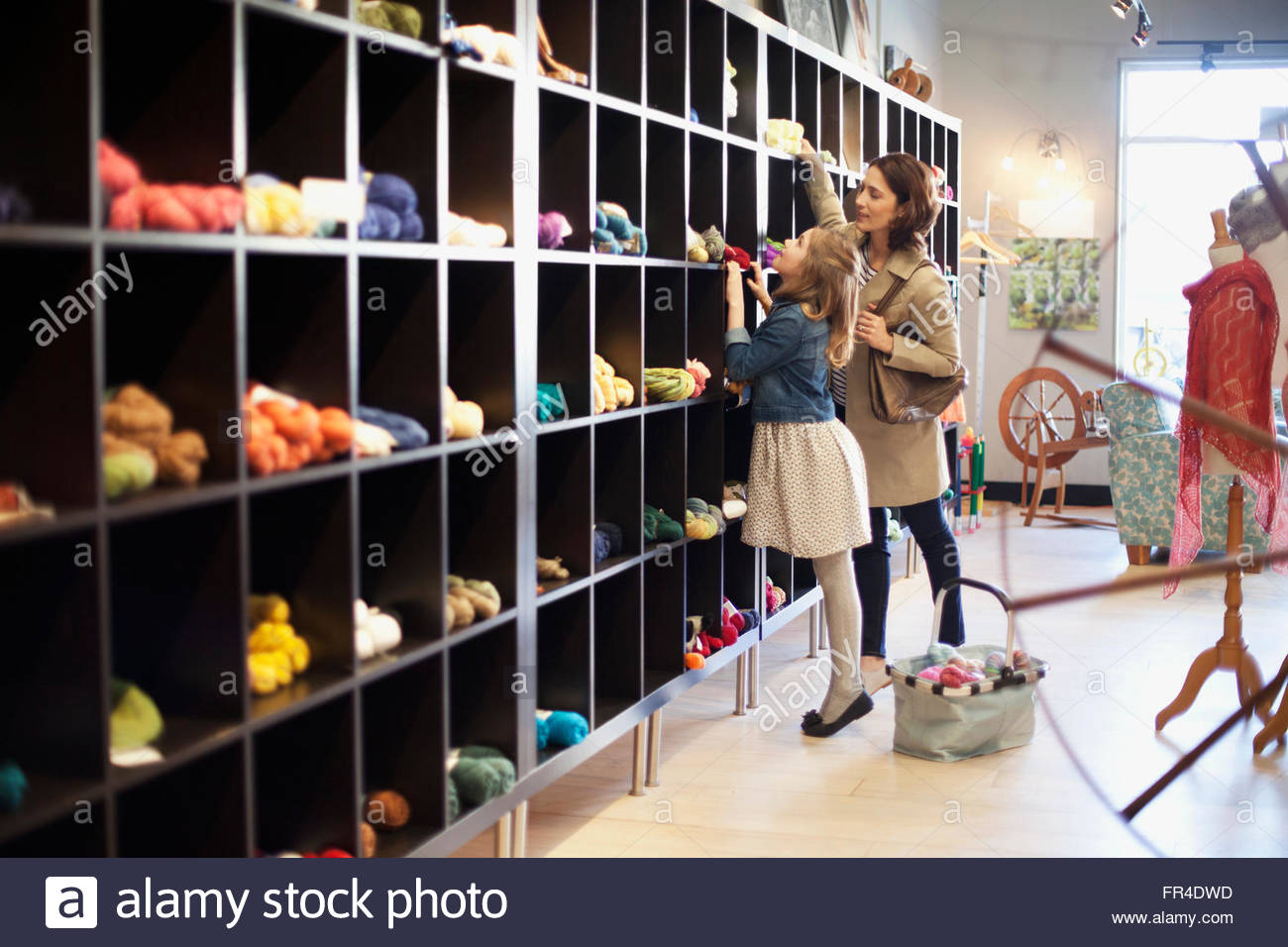mom and daughter choosing yarn Stock Photo Alamy