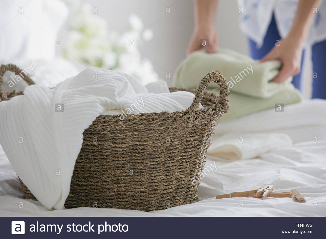 Folded towels in wicker basket hires stock photography and images Alamy