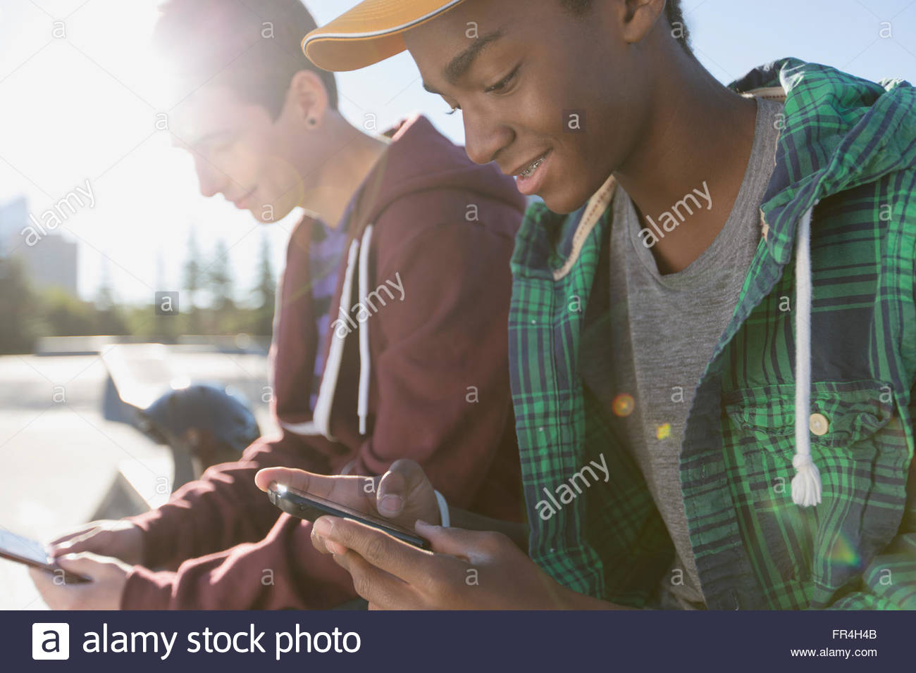 teenage boys using wireless technology outdoors Stock Photo - Alamy