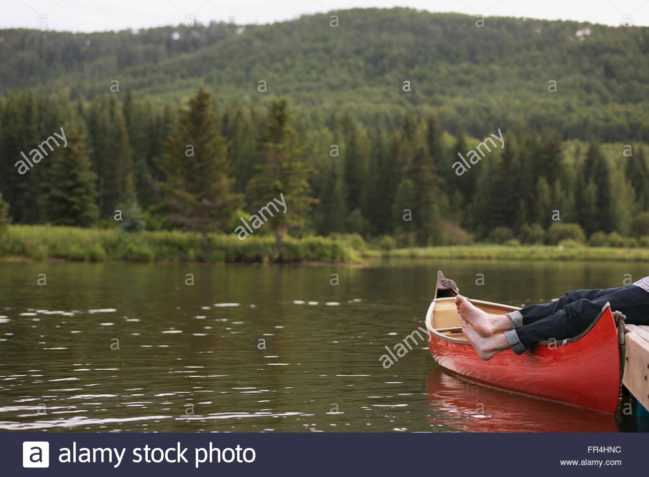 man relaxing at the end of boat dock Stock Photo