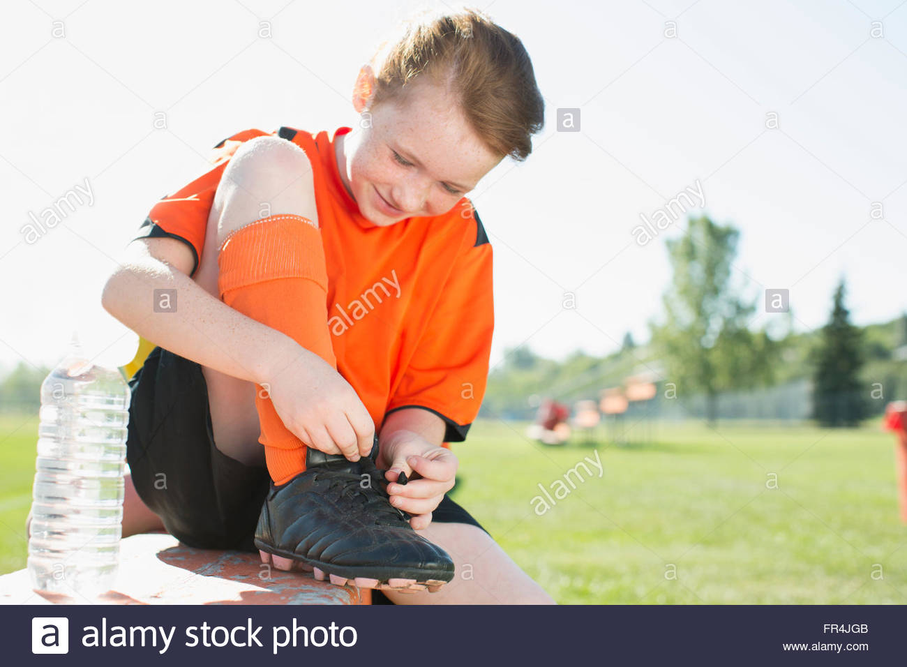Young female soccer player tying up laces Stock Photo Alamy