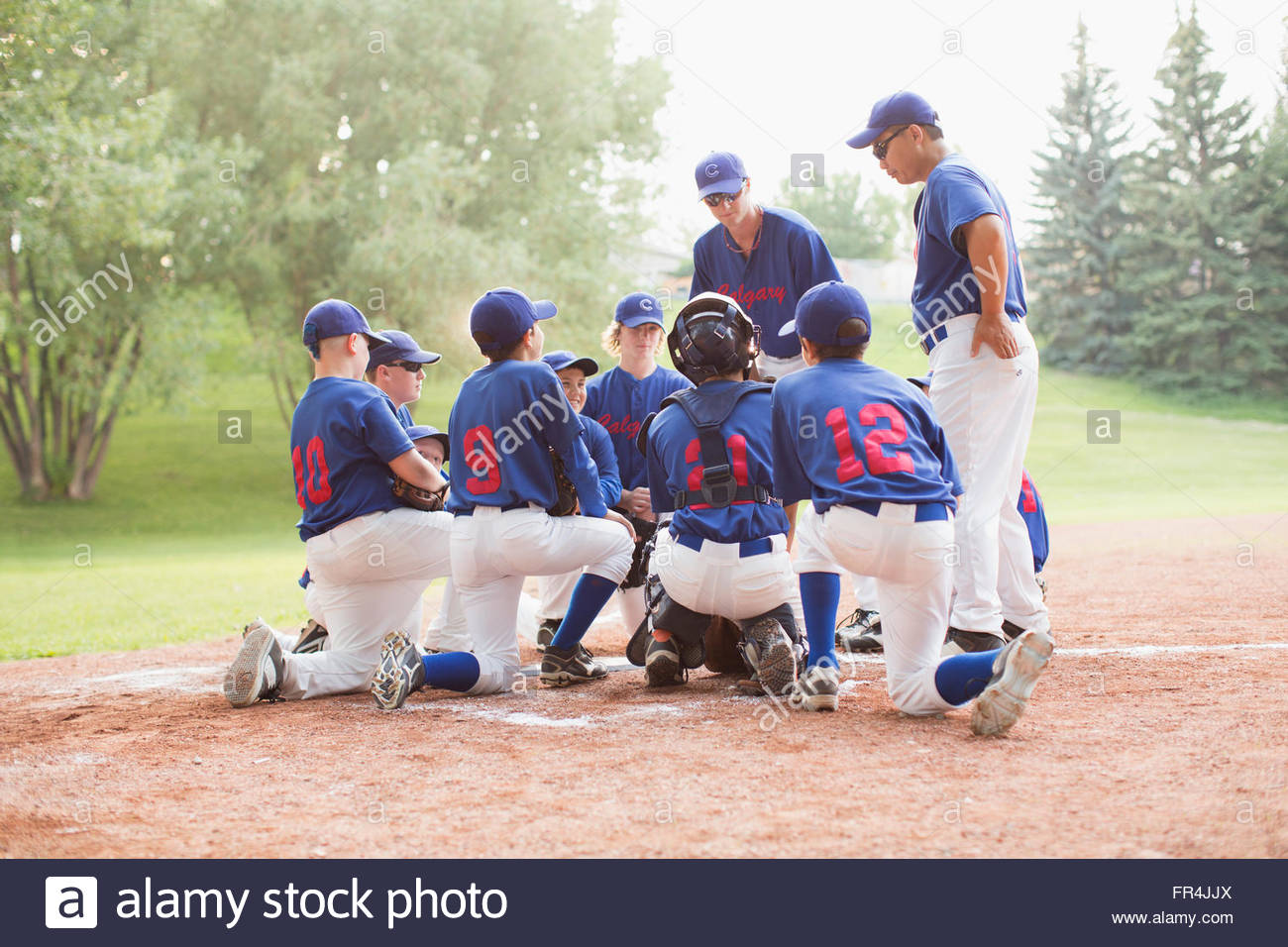 Coaches talking boys baseball team hires stock photography and images