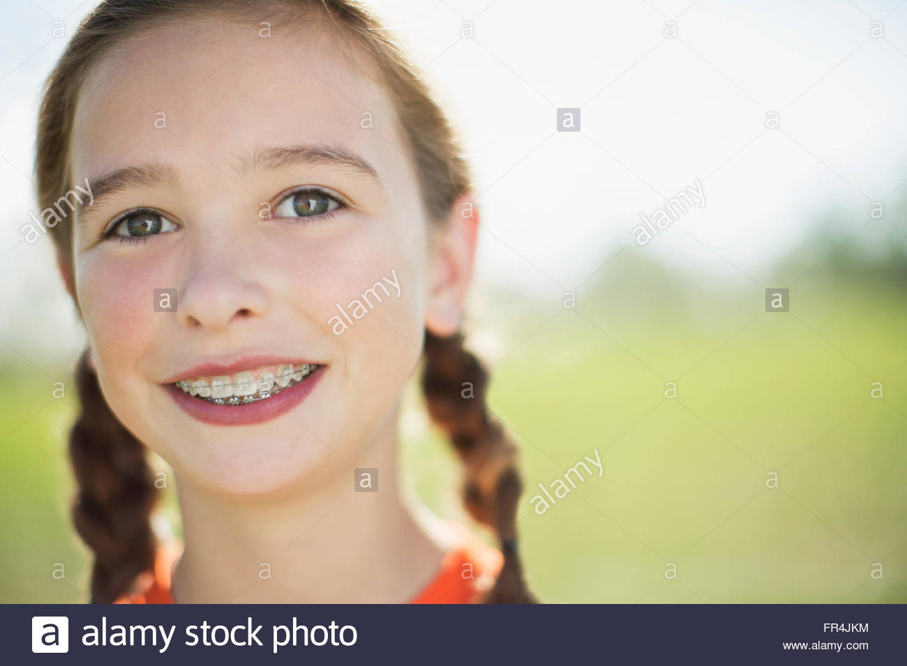 Portrait of female soccer player with pigtails and braces Stock Photo
