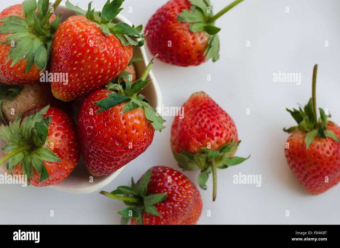 Strawberries In Bowl On White Fabric Background Stock Photo - Alamy