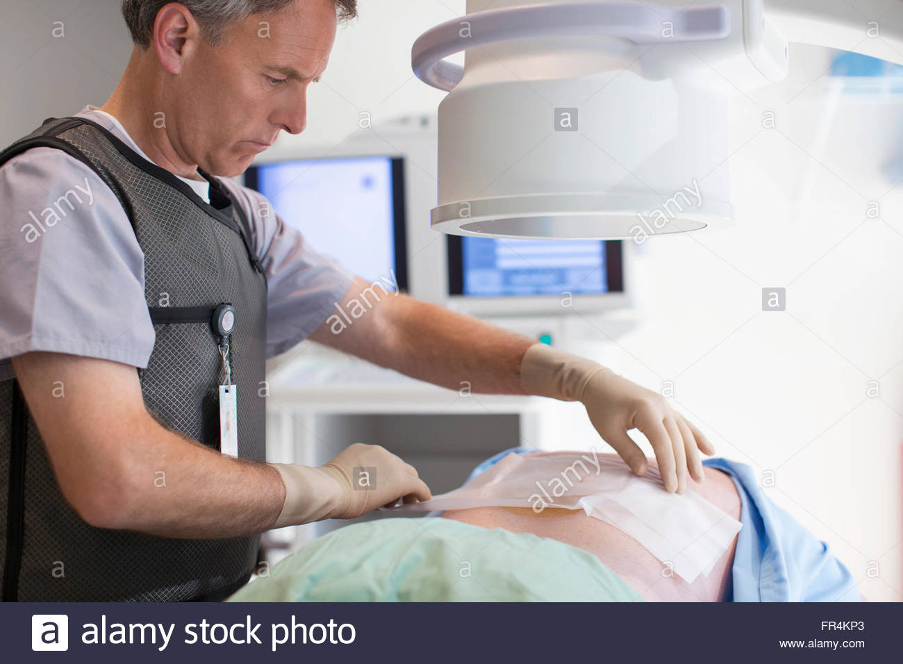 technician prepping patient for spinal xray Stock Photo Alamy