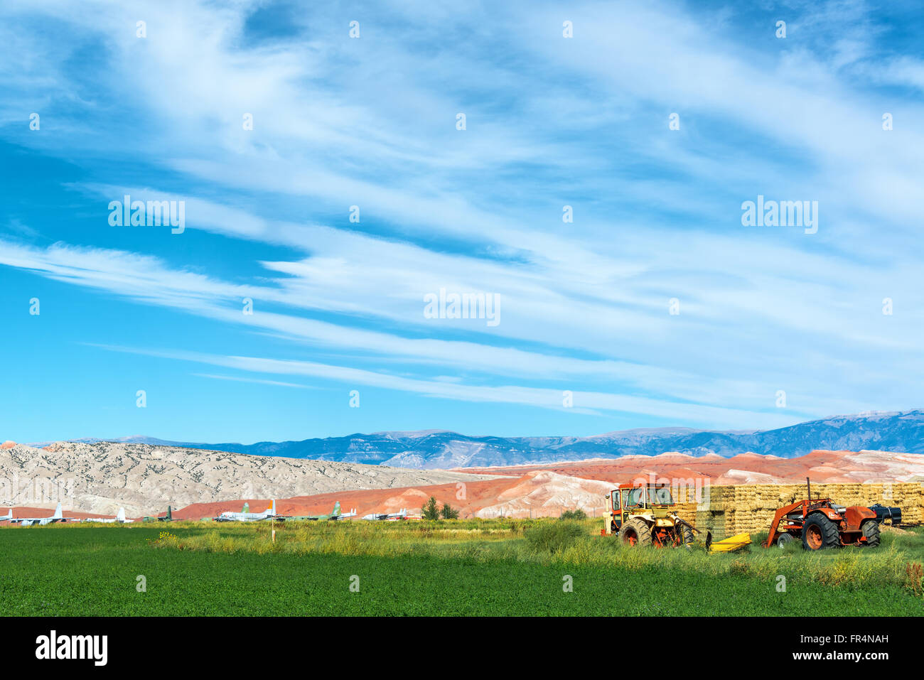 Landscape featuring tractors and an airplane boneyard in Greybull, Wyoming Stock Photo