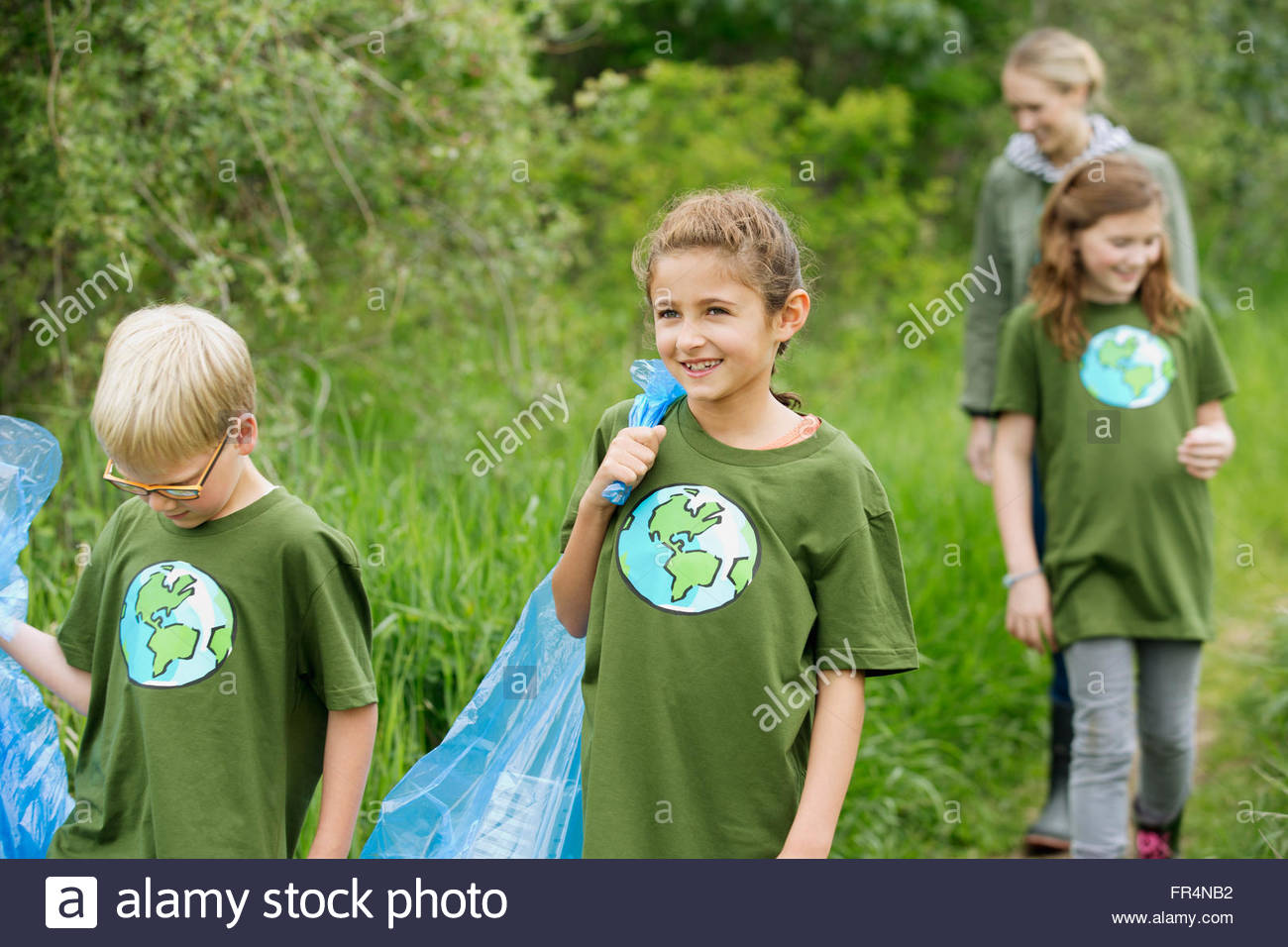 elementary students picking up garbage in the park Stock Photo