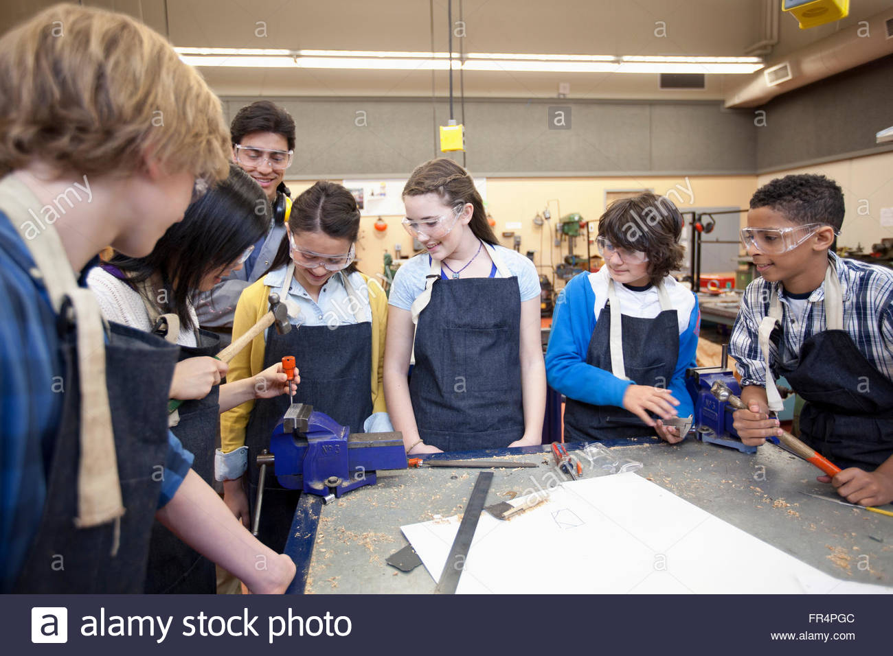 teacher demonstrating in machine shop class Stock Photo Alamy