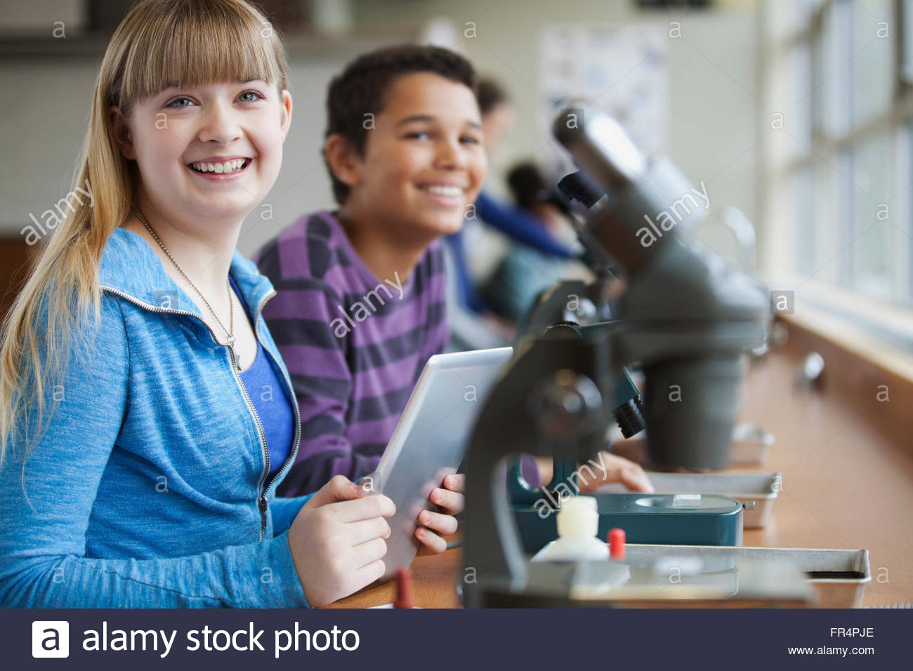 middle school students using microscopes Stock Photo Alamy