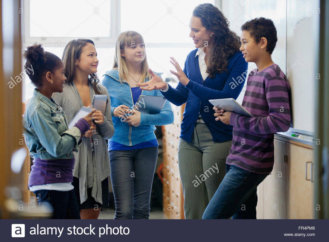 teacher explaining lesson to students Stock Photo