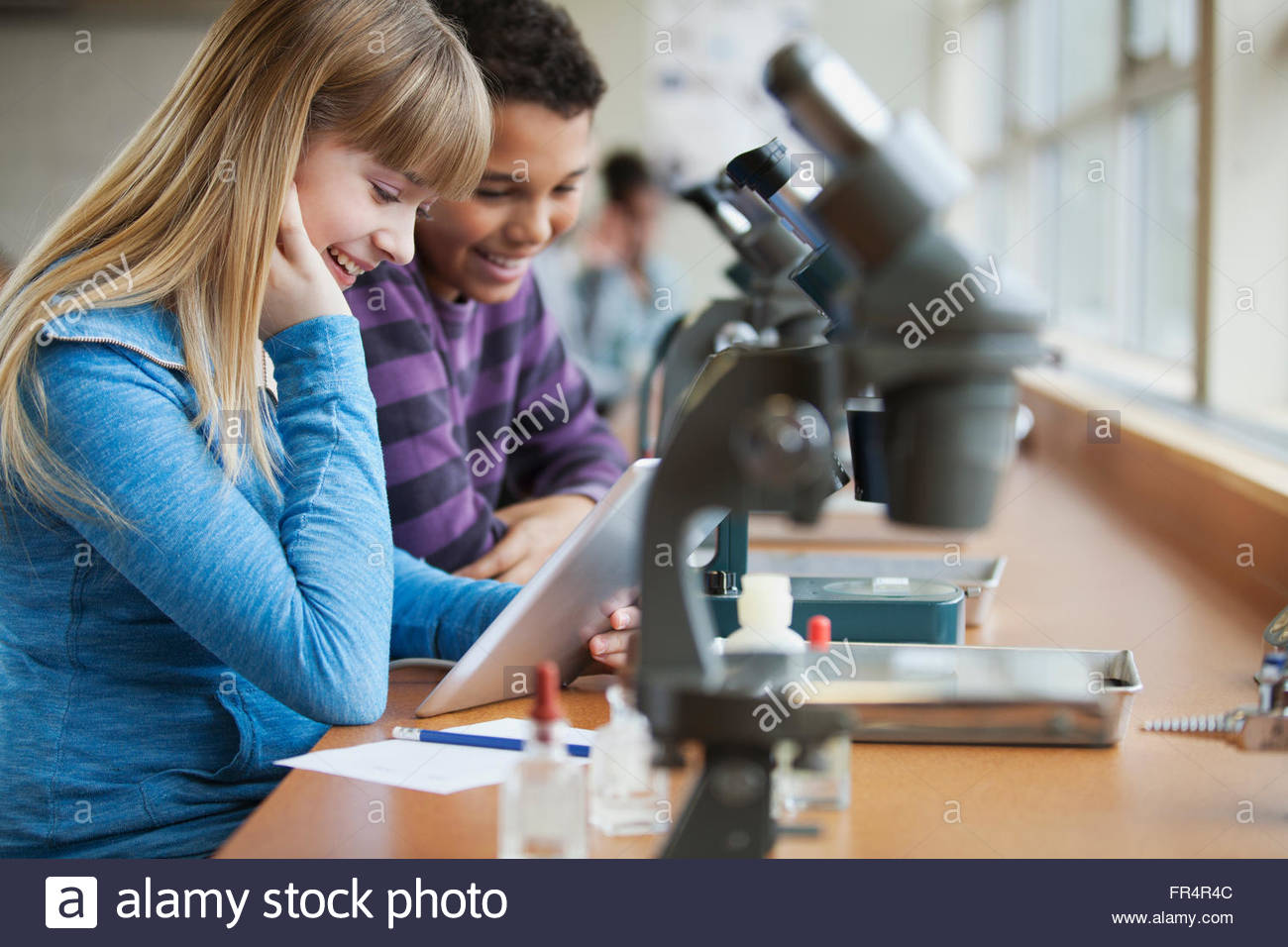 middle school student using microscopes Stock Photo Alamy