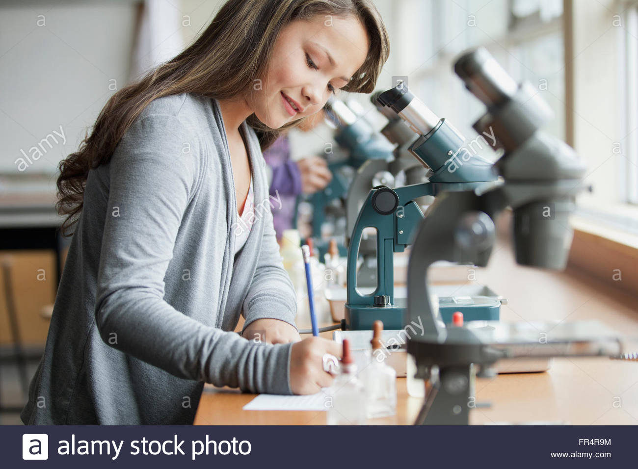 middle school student with microscope Stock Photo Alamy